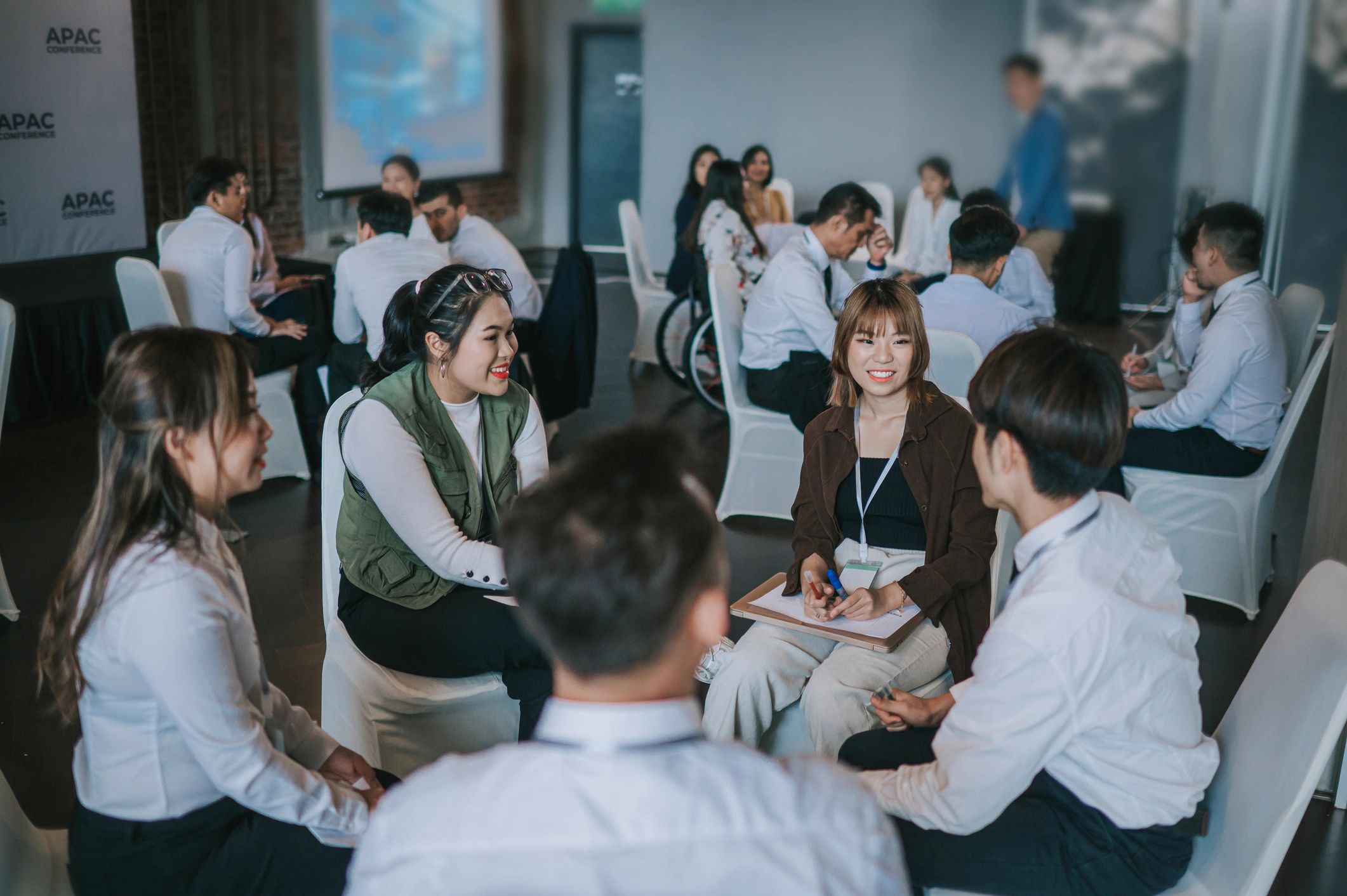Corporate event attendees participating in a professional conference session